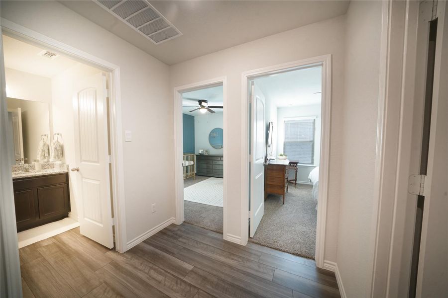 Corridor featuring dark wood-style flooring and baseboards