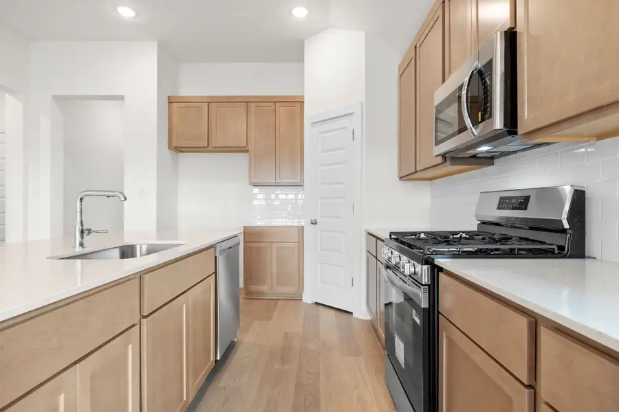 Kitchen in the Turquoise home plan by Trophy Signature Homes – REPRESENTATIVE PHOTO