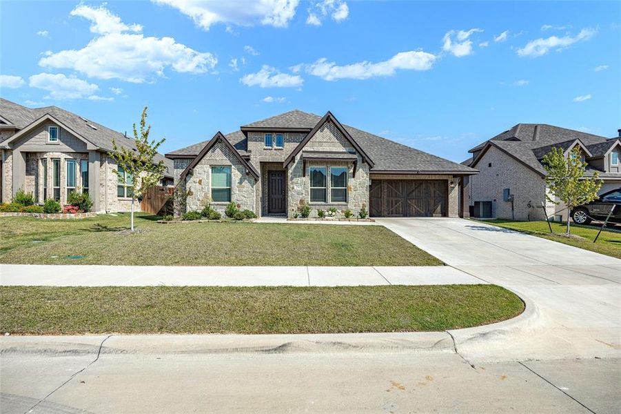Front exterior of a new home in The Oasis at North Grove 60-70, Waxahachie, TX, highlighting curb appeal (Image 19). Front exterior of a new home in The Oasis at North Grove 60-70, Waxahachie, TX, highlighting curb appeal (Image 19).