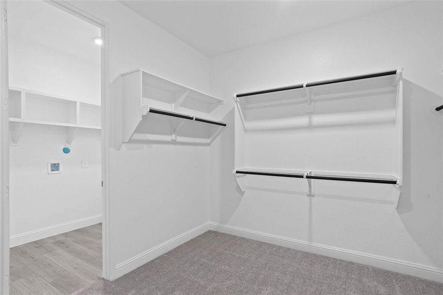 Look at this immaculate closet! With high shelving, multiple rows to hang clothing, you are sure to have enough room for all your belongings! Additional feature is the easy access into the laundry room from primary walk-in closet.