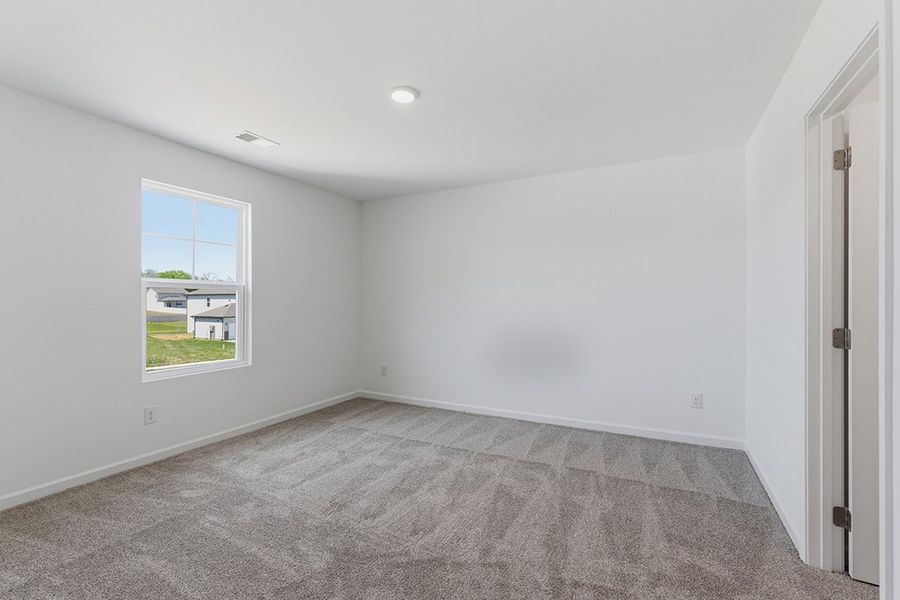 A room with a carpet and a window. A room with a carpet and a window.