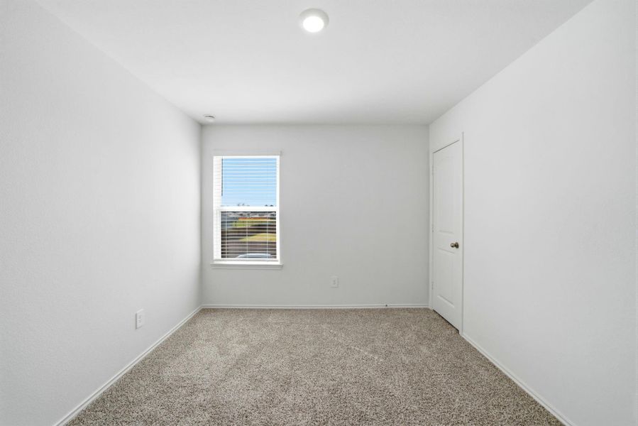 Sunlit secondary bedroom featuring a generous closet space.