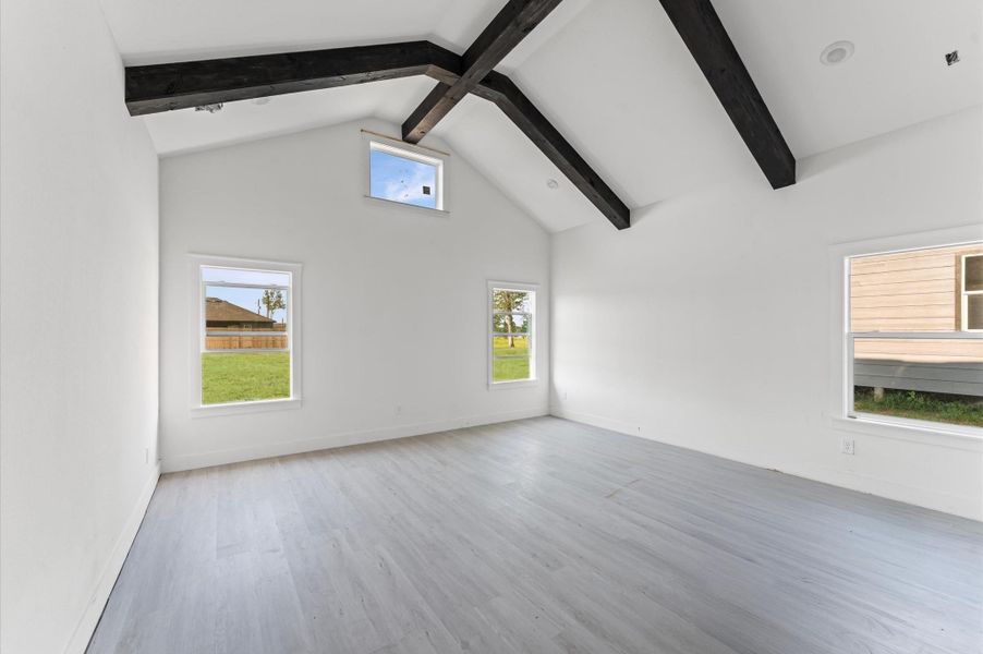 Expansive primary suite with soaring ceilings, natural light, and space to relax. Photos are representative of the same floor plan built by this builder. Finishes will be the same or similar.