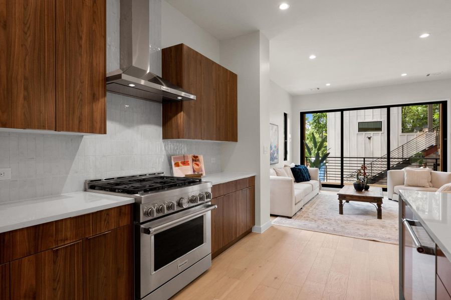 An open floorplan seamlessly connects the well-appointed kitchen with the bright living space. An open floorplan seamlessly connects the well-appointed kitchen with the bright living space.