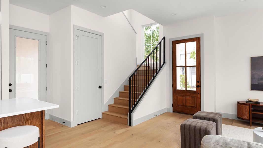 Foyer with light wood-type flooring, stairs, and recessed lighting