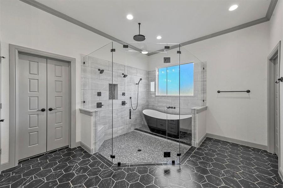 Bathroom featuring tile patterned floors, crown molding, and shower with separate bathtub