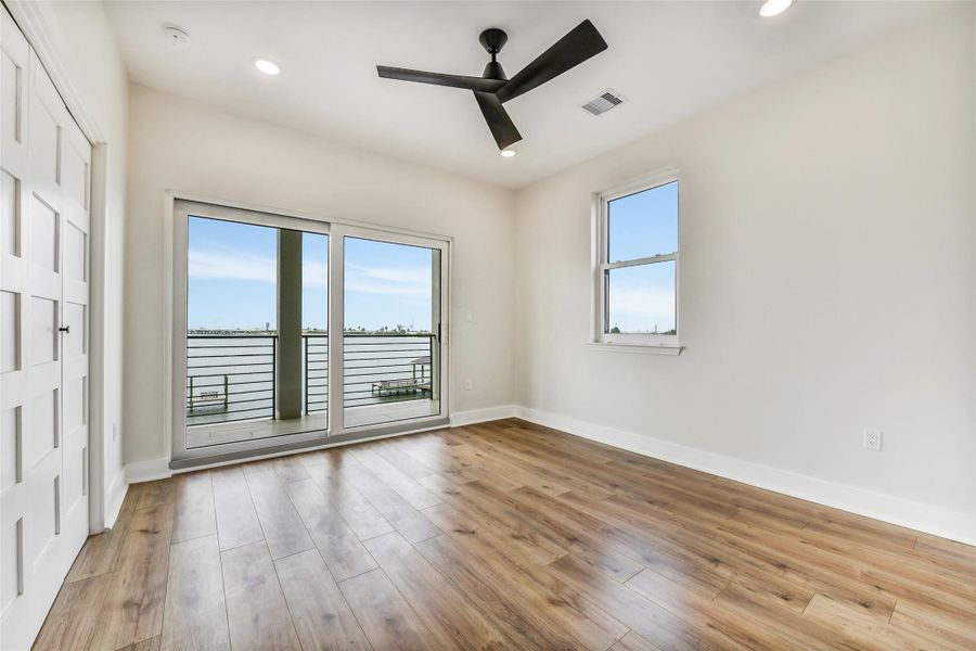 Waking up to the bay can become part of everyday life. This upstairs bedroom opens directly to the balcony, pairing sweeping water views with a private retreat. It would make an exceptional guest suite or peaceful room for family members. Waking up to the bay can become part of everyday life. This upstairs bedroom opens directly to the balcony, pairing sweeping water views with a private retreat. It would make an exceptional guest suite or peaceful room for family members.