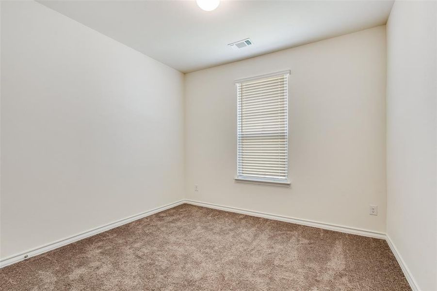 Carpeted empty room with baseboards Carpeted empty room with baseboards