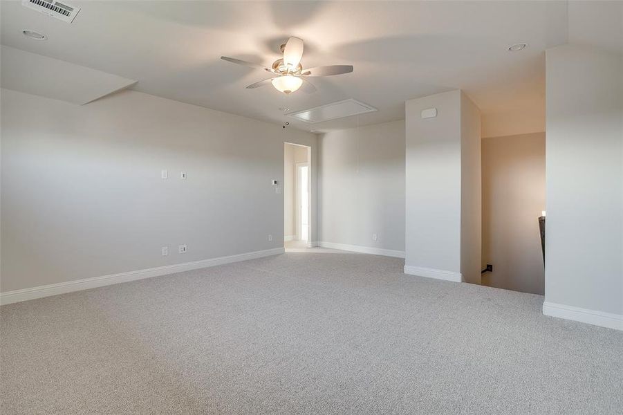 Spare room with carpet and ceiling fan