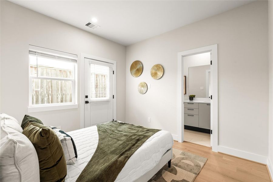 Located on the first floor, this secondary bedroom includes direct access to a full bath and an exterior door for added flexibility and privacy.