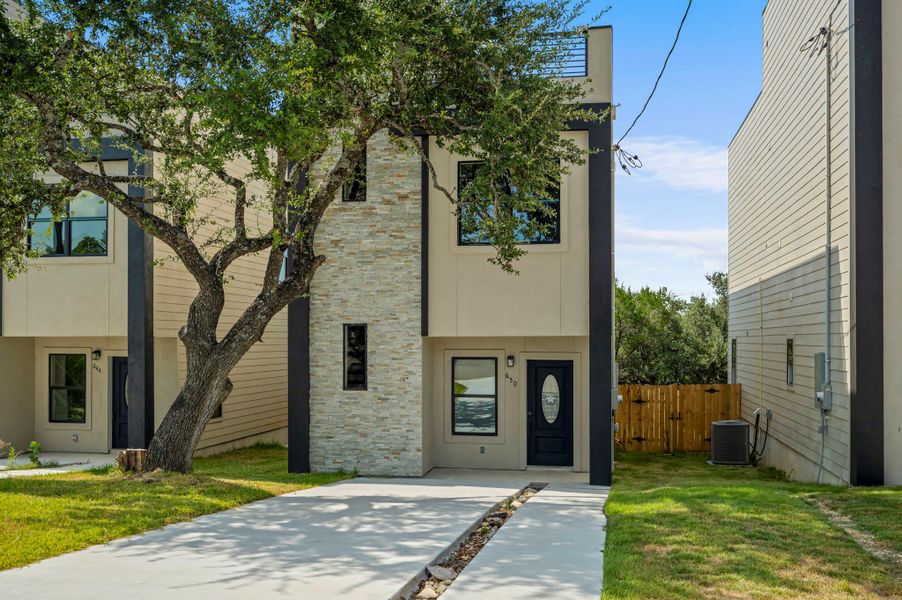 Modern home featuring stone siding and stucco siding
