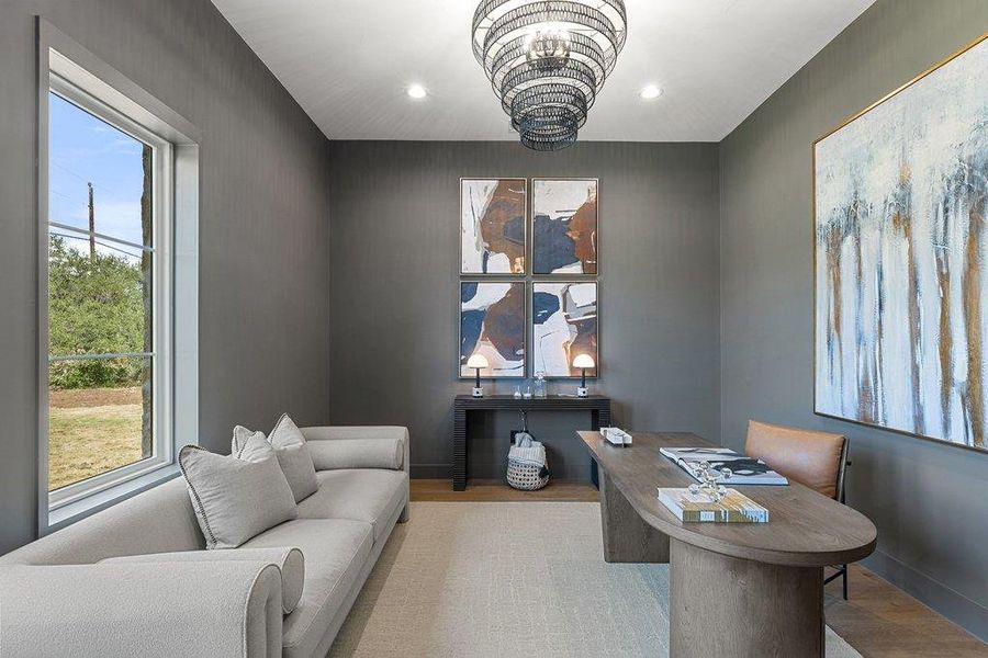 An inviting home office boasts a sophisticated palette and ample natural light, creating a productive atmosphere.