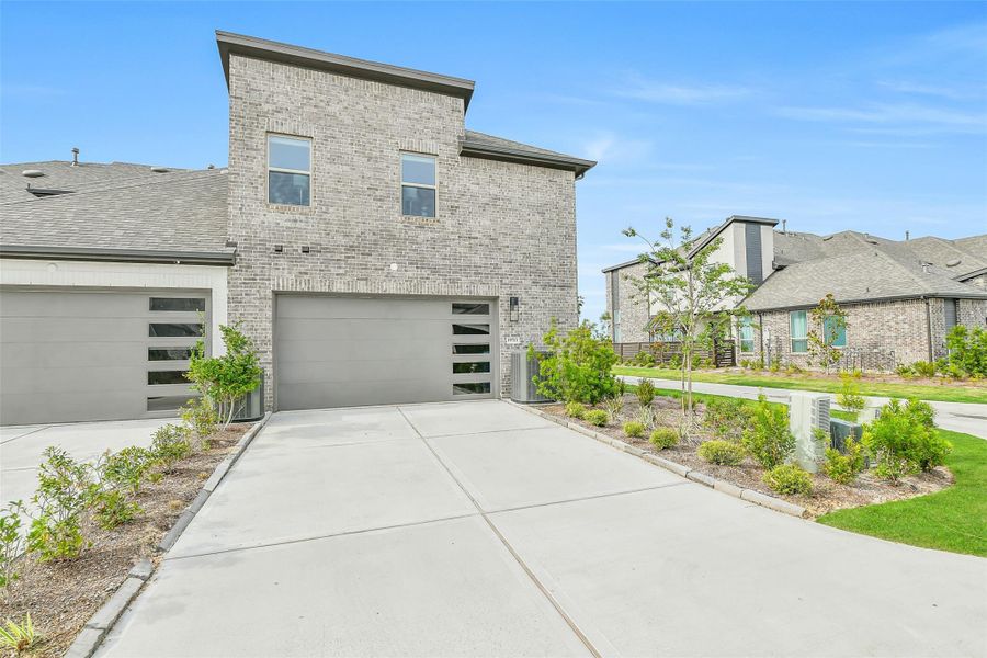 Front exterior of a new home in Bridgeland, Cypress, TX, highlighting curb appeal (Image 2). Front exterior of a new home in Bridgeland, Cypress, TX, highlighting curb appeal (Image 2).