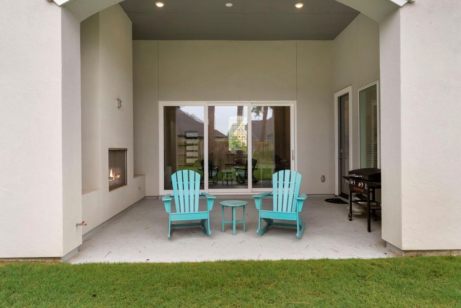 Large sliding doors connect the indoor living area to the covered outdoor patio.