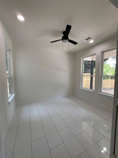 Spacious office with recessed lighting and tile floors