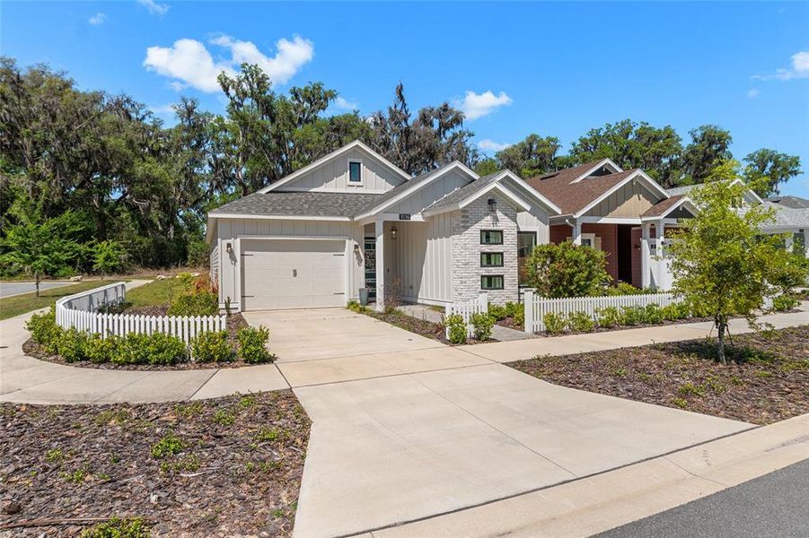 Front exterior of a new home in Fairway Pointe at West End, Newberry, FL, highlighting curb appeal (Image 24).