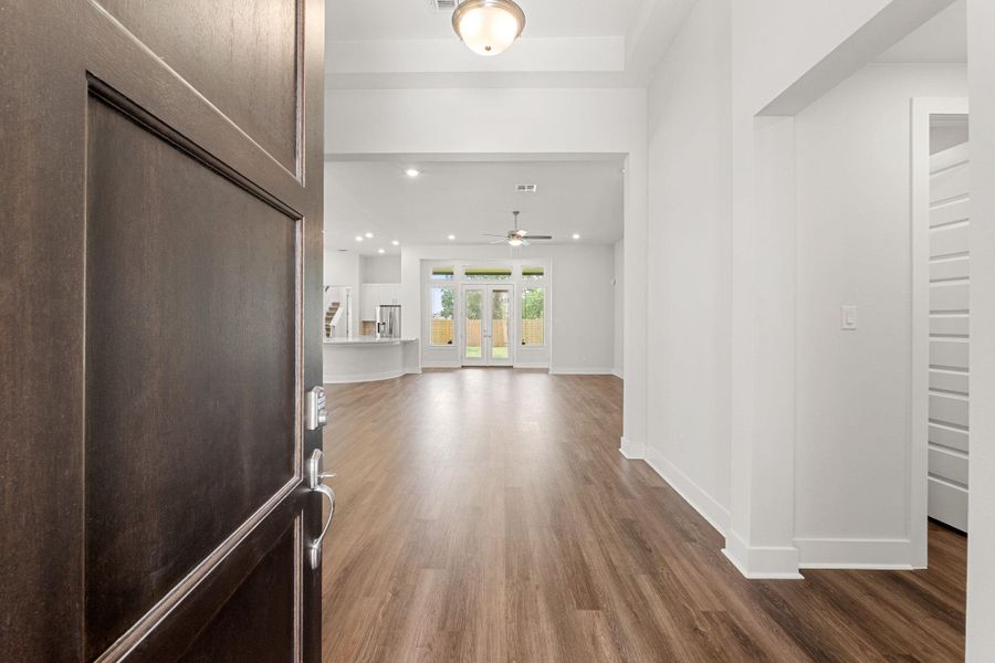 Entryway with dark wood-style floors, a ceiling fan, baseboards, and recessed lighting Entryway with dark wood-style floors, a ceiling fan, baseboards, and recessed lighting