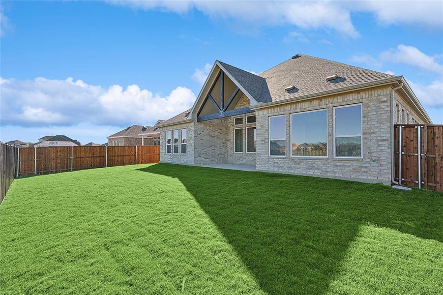 Back of house featuring a lawn