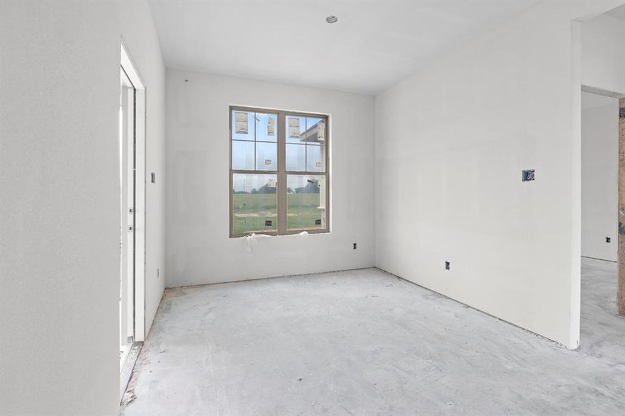 Unfinished interior space with neutral walls and a large window providing ample natural light Unfinished interior space with neutral walls and a large window providing ample natural light