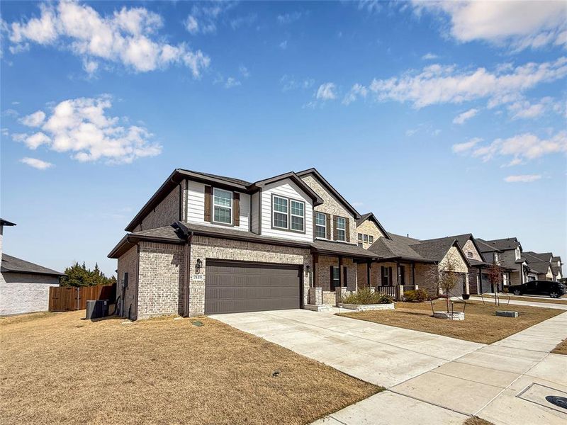 Front exterior of a new home in Travis Ranch, Forney, TX, highlighting curb appeal (Image 25).