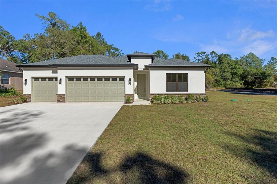 Front exterior of a new home in , Citrus Springs, FL, highlighting curb appeal (Image 1). Front exterior of a new home in , Citrus Springs, FL, highlighting curb appeal (Image 1).