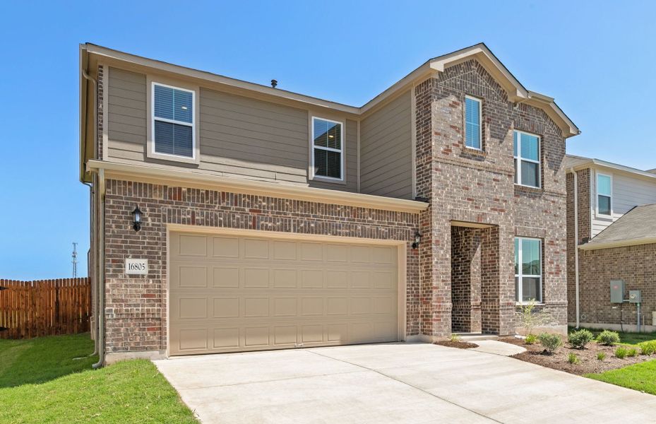 Front exterior of a new home in Lagos, Manor, TX, highlighting curb appeal (Image 2). Front exterior of a new home in Lagos, Manor, TX, highlighting curb appeal (Image 2).