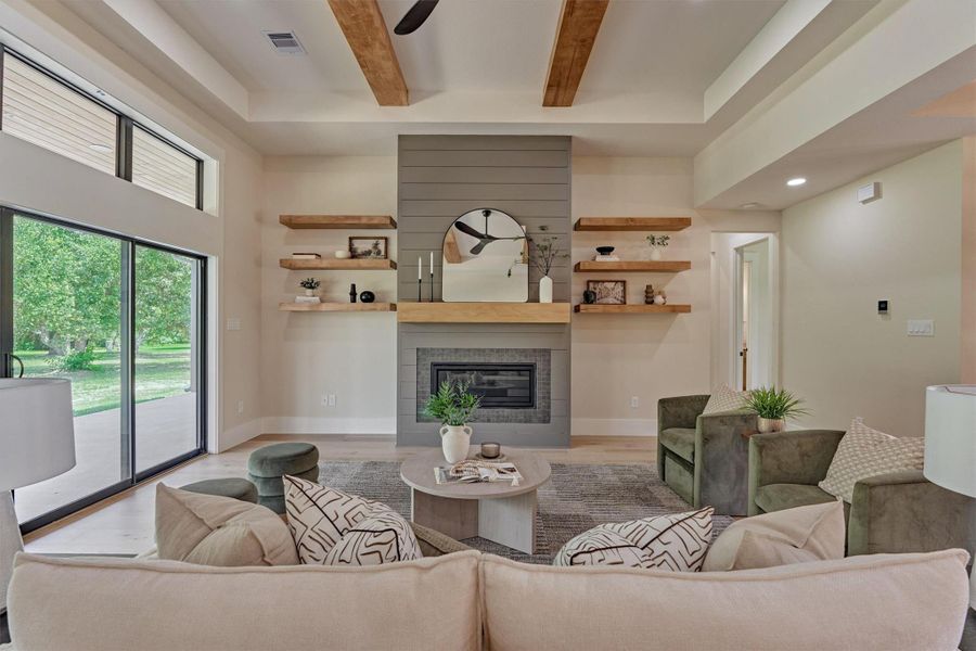 A closer look at the living room's shiplap fireplace wall, complete with a cozy gas fireplace and floating wood shelves on either side — the kind of styling that makes a house feel like home. A closer look at the living room's shiplap fireplace wall, complete with a cozy gas fireplace and floating wood shelves on either side — the kind of styling that makes a house feel like home.