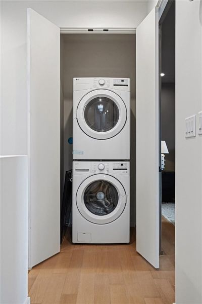 A dedicated laundry closet offers convenient stacked appliances within a clean, functional space.