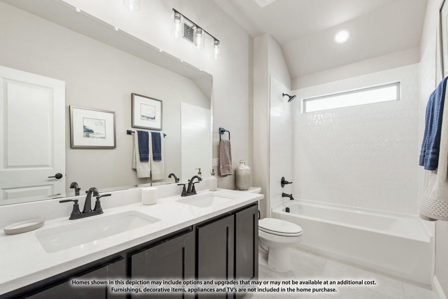 Bathroom with double sink vanity, dark cabinets, white countertop, and tub-shower combo with vaulted ceiling Bathroom with double sink vanity, dark cabinets, white countertop, and tub-shower combo with vaulted ceiling