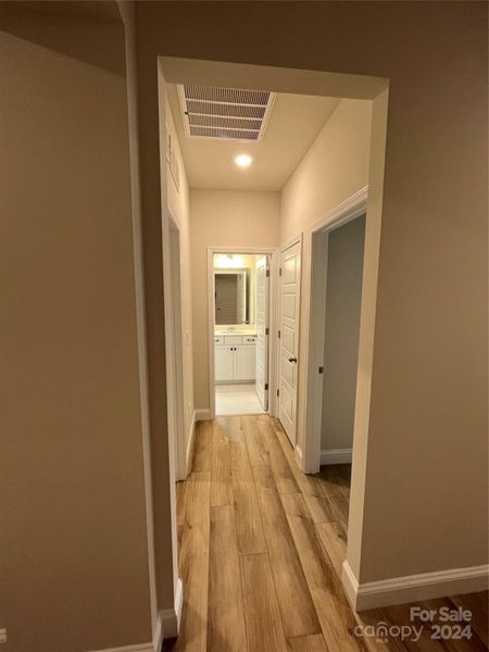 Right of the entryway, hallway to Secondary Bedroom, Laundry Room and First Full Bathroom (Main Level)