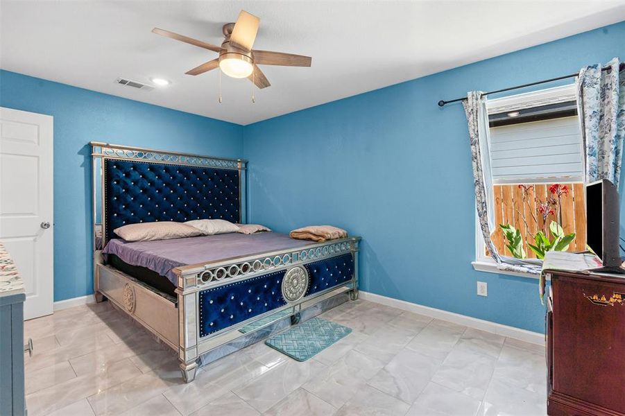 Bedroom with ceiling fan and baseboards Bedroom with ceiling fan and baseboards