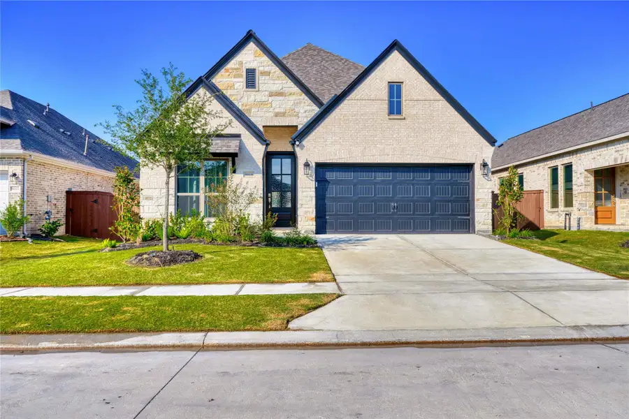 Front exterior of a new home in Meridiana 40'/45', Manvel, TX, highlighting curb appeal (Image 25).