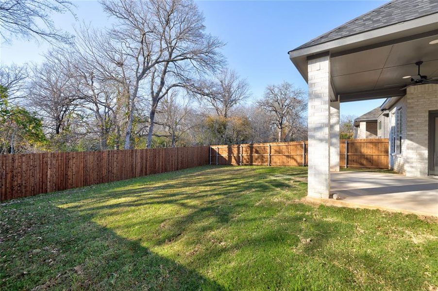 View of yard with ceiling fan and a patio area