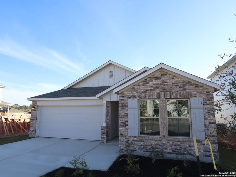 Front exterior of a new home in Hunters Ranch, San Antonio, TX, highlighting curb appeal (Image 27).