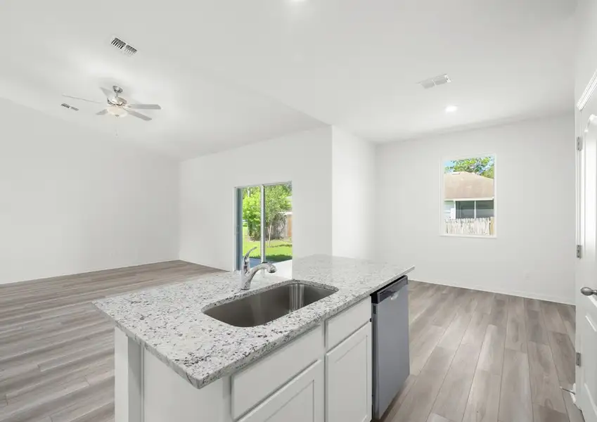 Kitchen island in the Braden - FL home in Fort Pierce, with granite countertops and an undermount sink.