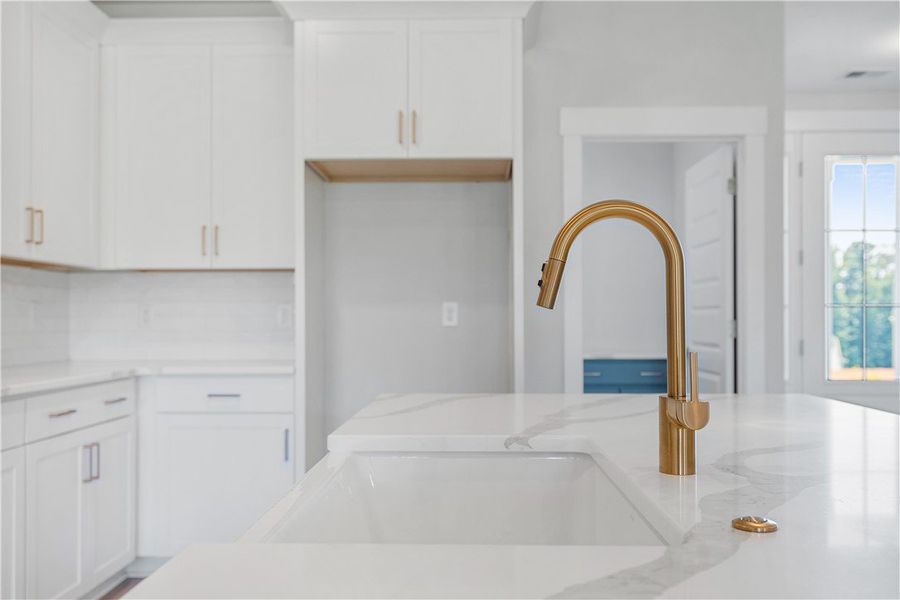 A sleek gold-toned faucet rises elegantly above a A sleek gold-toned faucet rises elegantly above a