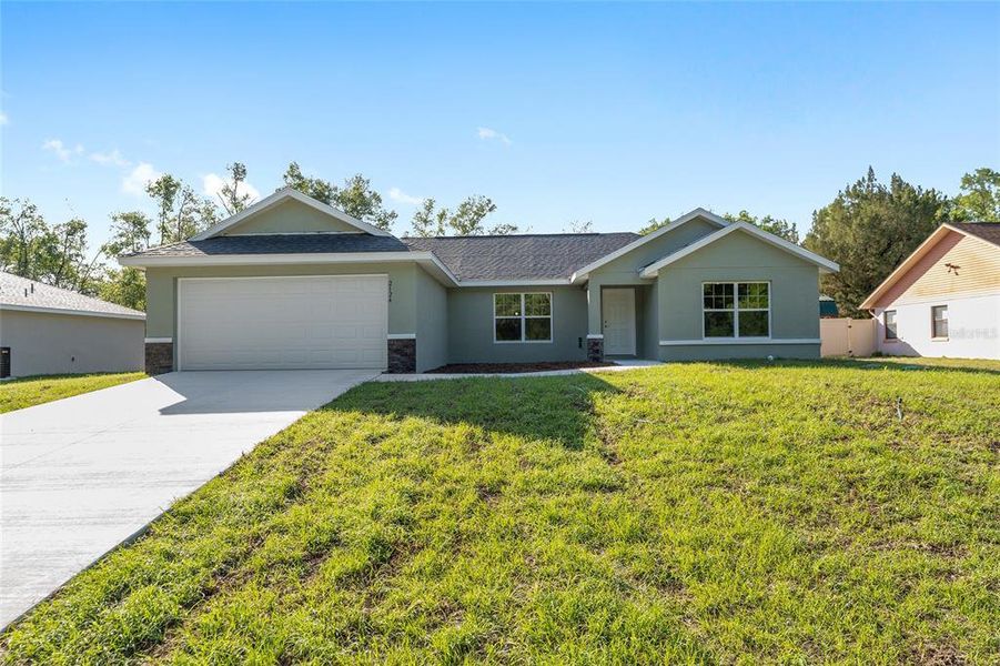 Front exterior of a new home in , Dunnellon, FL, highlighting curb appeal (Image 14).