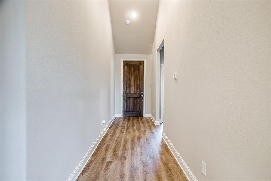Corridor featuring light wood-type flooring Corridor featuring light wood-type flooring