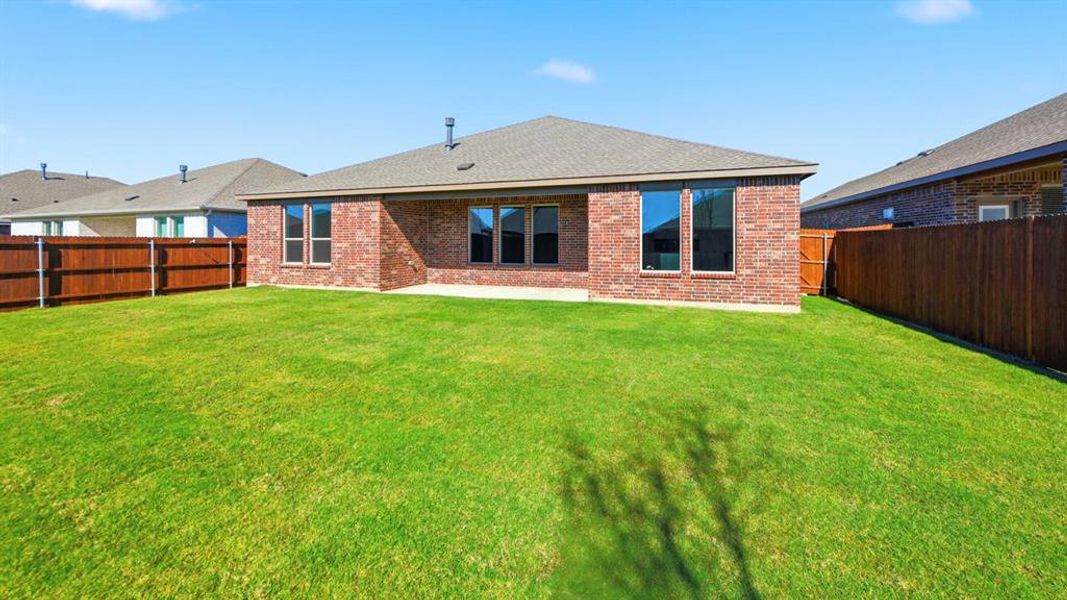 Back of property featuring brick siding, a patio area, a shingled roof, and a fenced backyard Back of property featuring brick siding, a patio area, a shingled roof, and a fenced backyard