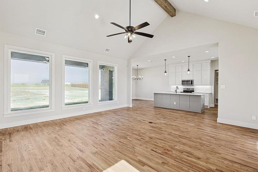 Vaulted Ceiling with large windows. Handscraped Hardwood floors