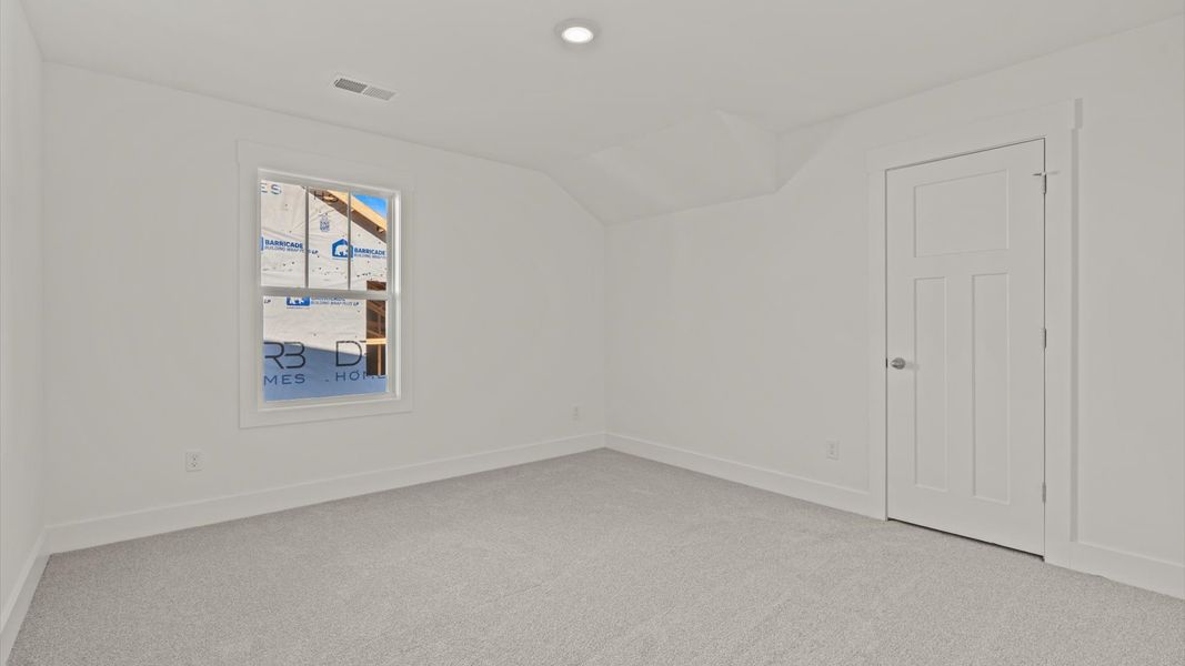 Inviting bedroom with tasteful finishes and large windows that create a fresh, open ambiance