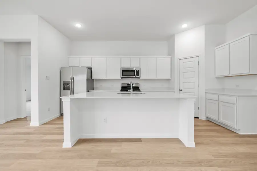 Kitchen in the Quartz home plan by Trophy Signature Homes – REPRESENTATIVE PHOTO