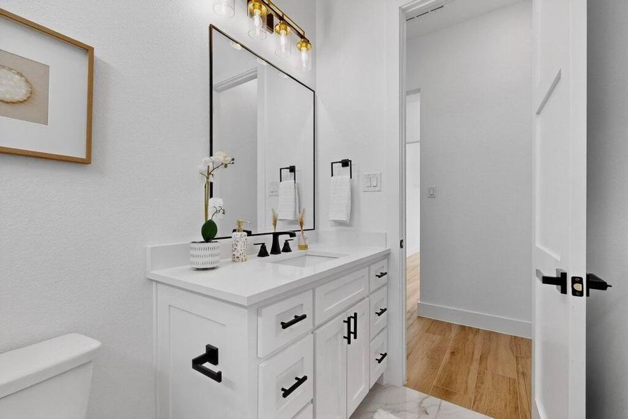 Half bath with vanity and light wood-style flooring Half bath with vanity and light wood-style flooring