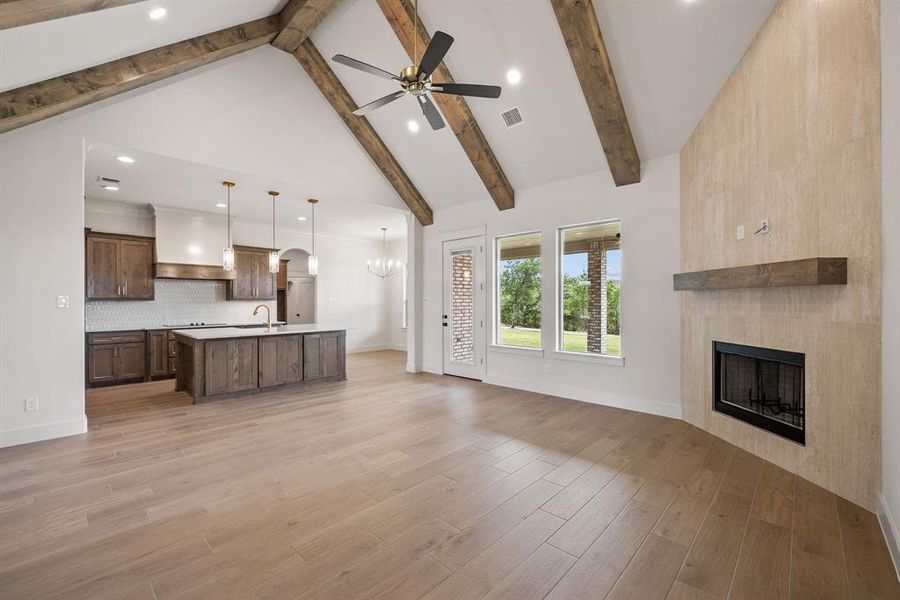 Vaulted ceiling featuring exposed wood beams and recessed lighting