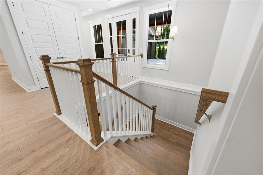 Gleaming hardwood floors and a classic wooden stai