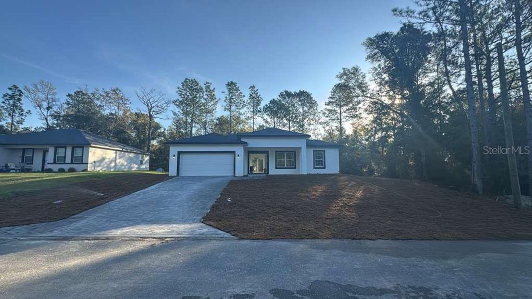 Front exterior of a new home in , Citrus Springs, FL, highlighting curb appeal (Image 1).