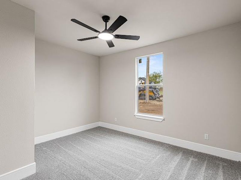 Spare room with light carpet and a ceiling fan Spare room with light carpet and a ceiling fan