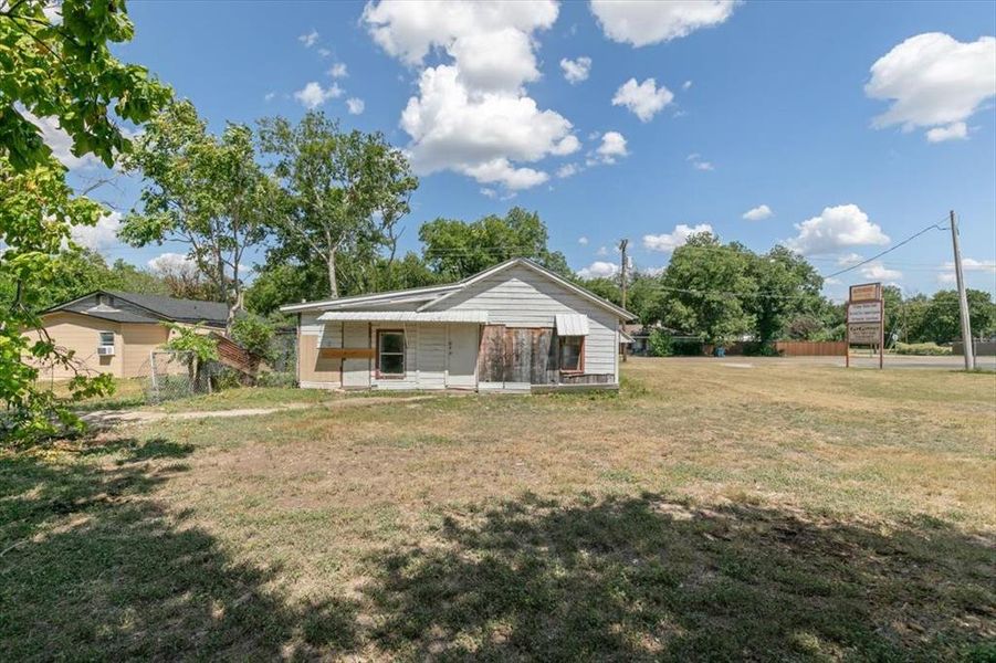 Rear view of property with a yard Rear view of property with a yard
