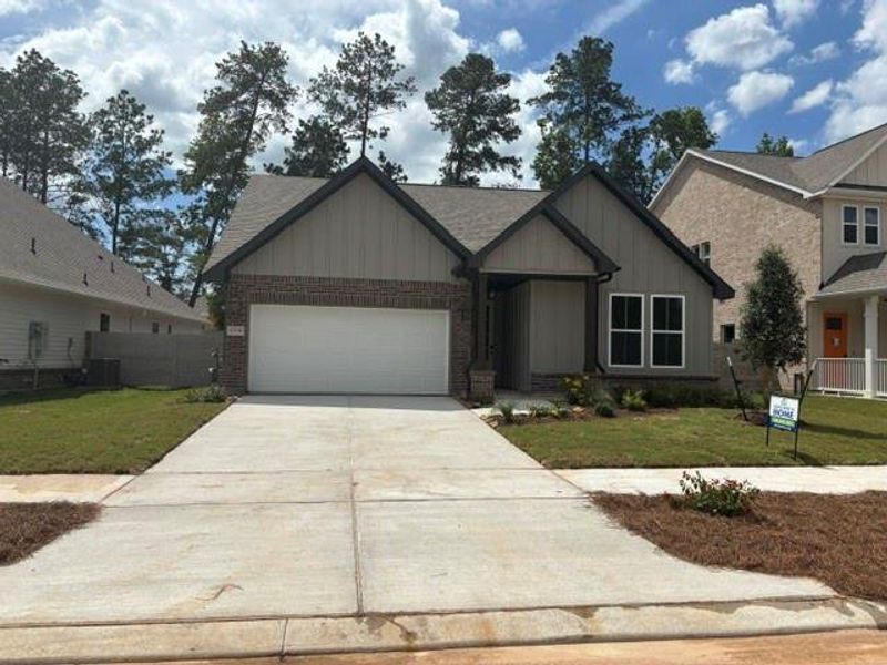 Front exterior of a new home in Two Step Farm, Montgomery, TX, highlighting curb appeal (Image 1). Front exterior of a new home in Two Step Farm, Montgomery, TX, highlighting curb appeal (Image 1).
