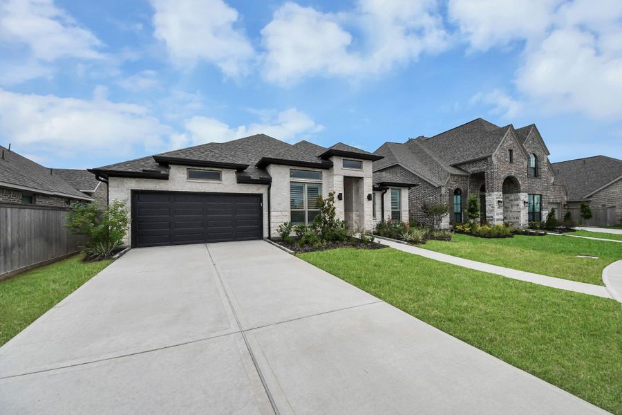 Front exterior of a new home in Valencia, Manvel, TX, highlighting curb appeal (Image 2). Front exterior of a new home in Valencia, Manvel, TX, highlighting curb appeal (Image 2).